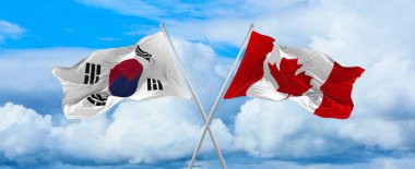 Güney Kore ve Kanada bayrakları rüzgarda dalgalanırken bayrak direkleri gökyüzüne karşı güneşli bir günde. İki ülke arasındaki ilişkiyi, diyaloğu sembolize ediyor. 3d illüstrasyon,
