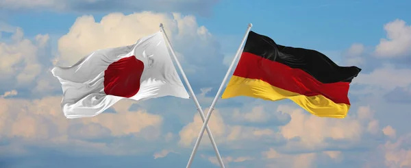 Flaggor Japan Och Förbundsrepubliken Tyskland Vinka Vinden Flaggstänger Mot Himlen — Stockfoto