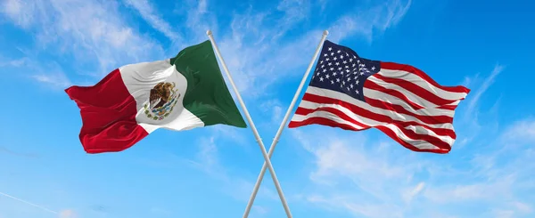 flags of USA and Mexico waving in the wind on flagpoles against the sky with clouds on sunny day. Symbolizing relationship, dialog between two countries. 3d illustration,