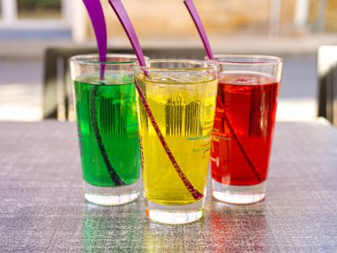 Three-color drink glasses in restaurant terrace