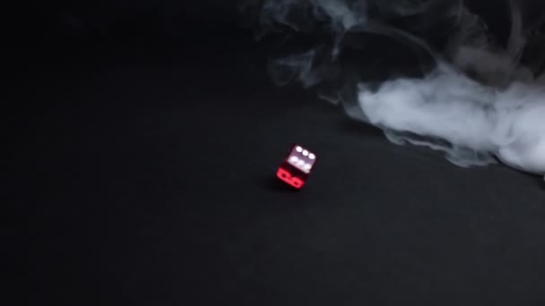 Red Dice Spinning Smoke Black Achtergrond Een Enkele Rode Dobbelsteen — Stockvideo