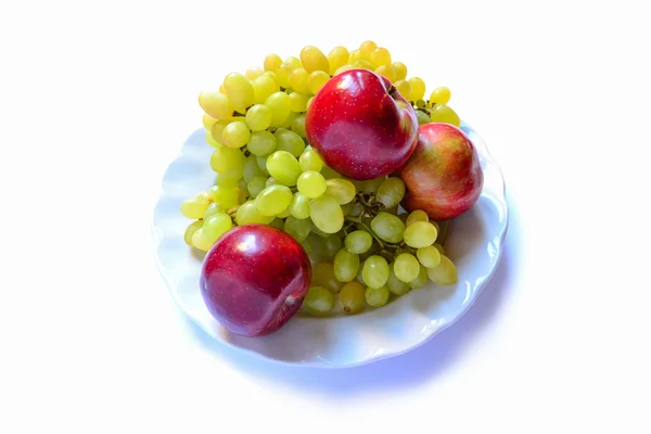 Grapes with apples on the plate isolated on white background — Stock Photo, Image