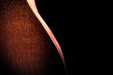 Ukulele 'nin karanlıkta izole edilmiş arka yüzünün sanatsal görüntüsü