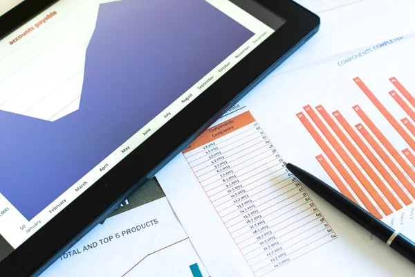 Charts and diagrams on tablet and papers