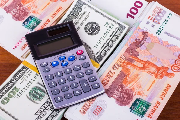 A lot of money in different currencies and calculator — Stock Photo, Image