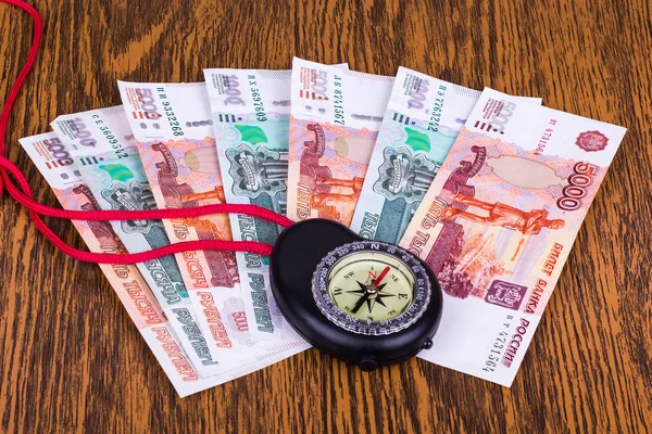 Money and Compass on the table — Stock Photo, Image