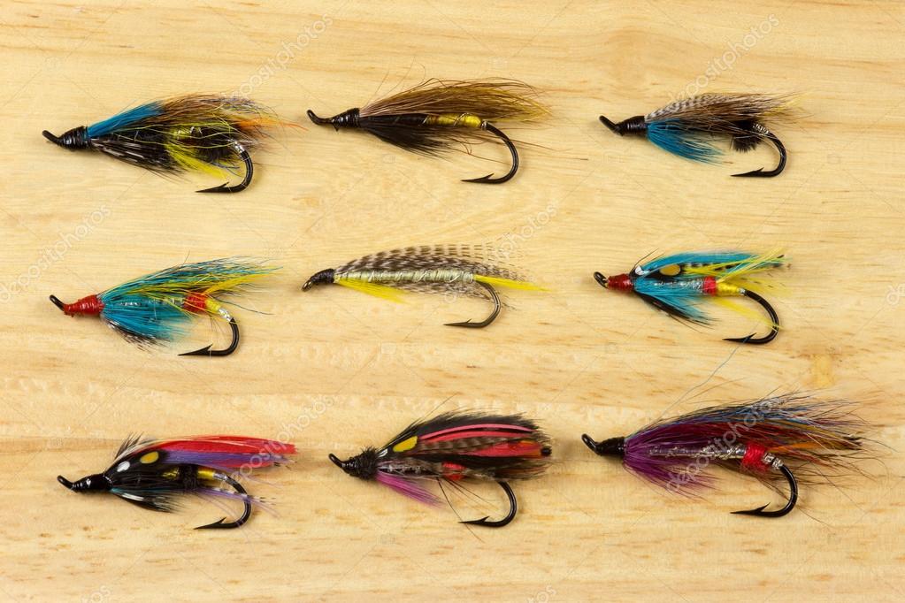 Traditional Salmon Fishing Flies on a Wooden Background Stock