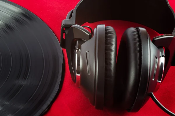 LP Record and earphones on Red Felt Surface — стоковое фото