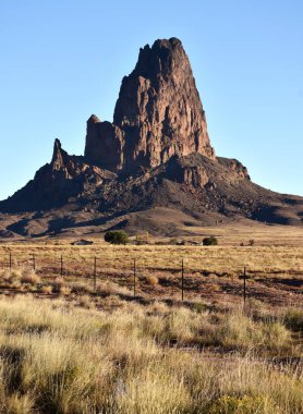 Agathla Peak (Agathlan) is a peak south of Monument Valley, Arizona. The mountain is considered sacred by the Navajo.