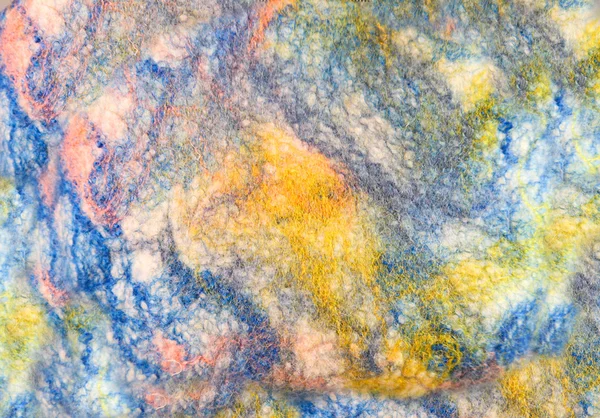 Texture colored felted fabric of dyed sheep's wool and viscose.