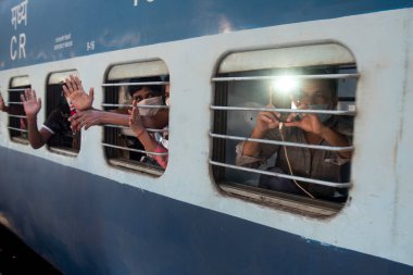 MUMBAI / INDIA - 8 Mayıs 2020: Göçmen işçiler, LTT Terminali 'ndeki evlerine dönüş yolculukları için bir tren dalgalarının içinde oturuyorlar.