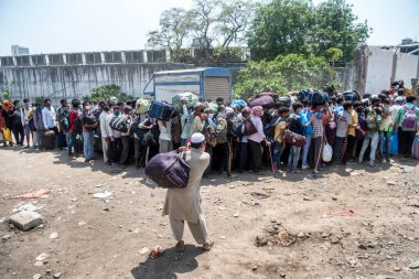 MUMBAI / INDIA - 14 Mayıs 2020: Göçmen işçiler, Coronavirus 'un yayılmasına karşı önleyici bir önlem olarak, yurt çapındaki tecrit sırasında evlerine dönüş yolculuklarında özel trene binmeye çalışıyorlar.