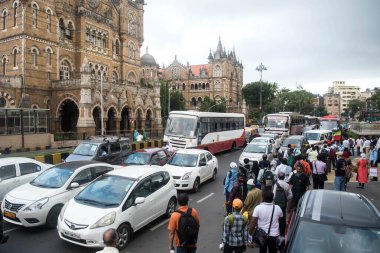 MUMBAI/INDIA- JUNE 10, 2020: Commuters wearing a facemask wait to board a public transport bus in Mumbai. India has begun gradually lifting its restrictions imposed by the government.