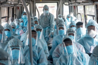 MUMBAI/INDIA- JUNE 17, 2020: Health workers wearing protective kit arrive at the COVID health check up camp at Ramabai colony slum during the COVID-19 Coronavirus pandemic.