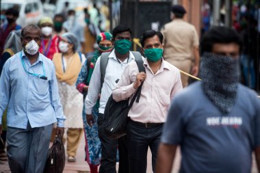 MUMBAI/INDIA -JUNE 17, 2020: Passenger arrive to board a suburban train at Chhatrapati Shivaji Maharaj terminus. India has begun gradually lifting its restrictions imposed by the government as a preventive measure against the COVID-19 coronavirus.
