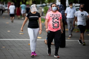 MUMBAI/INDIA- JUNE 17, 2020: People walk at the Marine drive promenade, after the government eased a lockdown imposed as a preventive measure against the COVID-19 coronavirus.