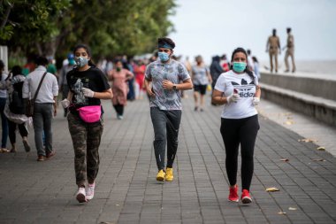 MUMBAI/INDIA- JUNE 17, 2020: People walk at the Marine drive promenade, after the government eased a lockdown imposed as a preventive measure against the COVID-19 coronavirus.