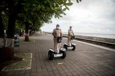MUMBAI/INDIA- JUNE 17, 2020: Mumbai Police patrol on Segway electric scooter at the Marine drive promenade, after the government eased a lockdown imposed as a preventive measure against the COVID-19 coronavirus.