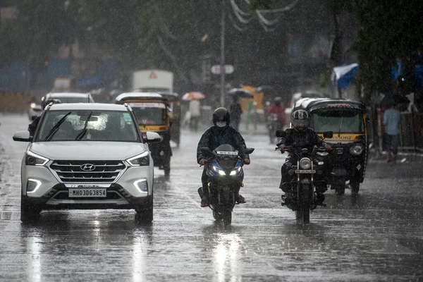 MUMBAI / INDIA - 5 AĞUSTOS 2020: Sakinaka 'da sağanak yağış sırasında banliyö araçları sürüyor.
