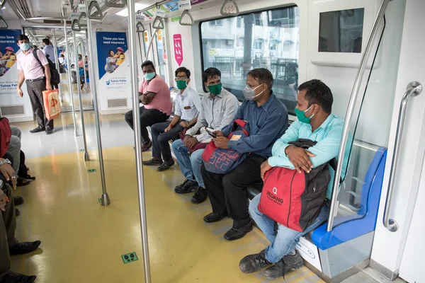 MUMBAI / INDIA - 19 Ekim 2020: Andheri metro istasyonunda metro istasyonunda seyahat ederken maske takan yolcular, Covid-19 Coronavirus salgını nedeniyle metro şebekesi kapandıktan sonra hizmetlerine devam ettiler
