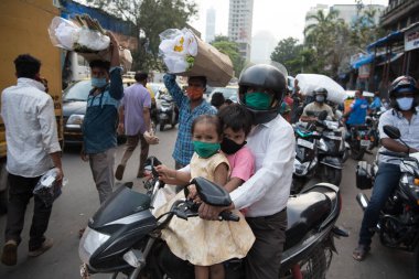 MUMBAI / INDIA - 24 Ekim 2020: Hindu Dussehra festivali vesilesiyle bir motosikletçi Dadar pazarına doğru yola çıktı.