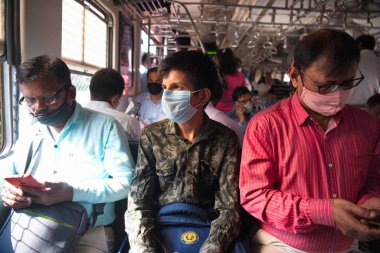MUMBAI-INDIA - February 10, 2021: Passenger travel in Mumbai local train with taking safety measures, as India has begun gradually lifting its restrictions imposed by the government