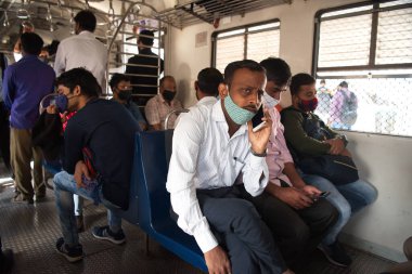 MUMBAI-INDIA - February 10, 2021: Passenger travel in Mumbai local train with taking safety measures, as India has begun gradually lifting its restrictions imposed by the government