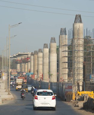 MUMBAI - INDIA - March 7, 2021: Concrete pillars on a section of an under construction elevated corridor of The Mumbai Metro Rail project on Jogeshwari  Vikhroli Link Road.