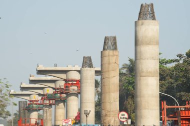 MUMBAI - INDIA - March 7, 2021: Concrete pillars on a section of an under construction elevated corridor of The Mumbai Metro Rail project on Jogeshwari  Vikhroli Link Road.