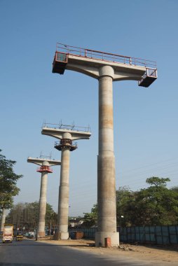 MUMBAI - INDIA - March 7, 2021: Concrete pillars on a section of an under construction elevated corridor of The Mumbai Metro Rail project on Jogeshwari  Vikhroli Link Road.