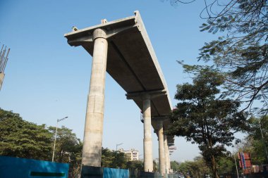 MUMBAI - INDIA - March 7, 2021: Concrete pillars on a section of an under construction elevated corridor of The Mumbai Metro Rail project on Jogeshwari  Vikhroli Link Road.