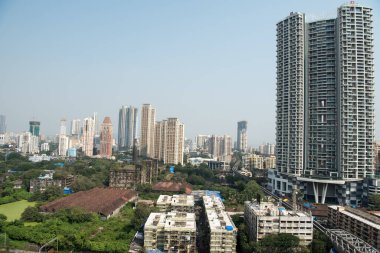 MUMBAI / INDIA - 27 Ekim 2020: Mumbai Parel 'de bir Mumbai yerel treni geçerken, konut ve ticari binaların genel görünümü.