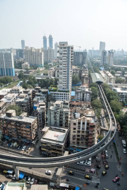 MUMBAI / INDIA - 27 Ekim 2020: Ticari ve konut binaları ayakta dururken, Currey yolunda raylı tren görüldü.