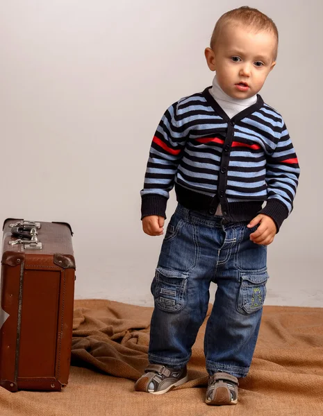 İki, üç yıl yaşlı erkek bebek taşımak büyük bavul bir w izole — Stok fotoğraf