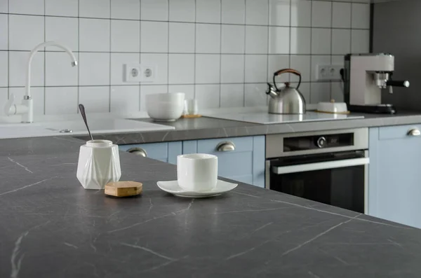 Modern stylish blue and gray kitchen with tea and coffee making facilities