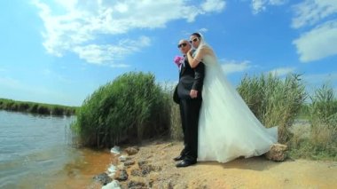 Kucaklayan ve birbirlerine su birikintisi yakın öpüşme genç güzel yeni evliler