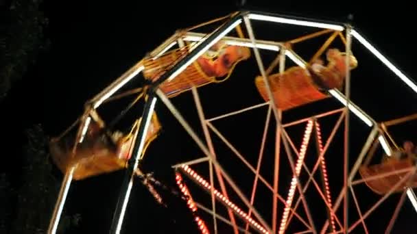 The old carousel in a small provincial park at night. — Stock Video