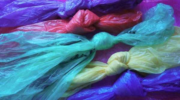 Plastic bags of different rainbow colors tied in a knot. International plastic bag free day. Say no to plastic. Go green. Save nature. Save ocean. World ocean day. Company against plastic bags.