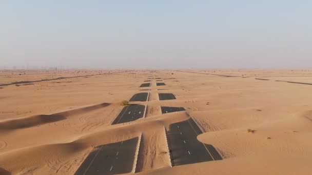 Homokdűnék által eltemetett sivatagi út légi kilátása. Dubai, Egyesült Arab Emírségek. — Stock videók
