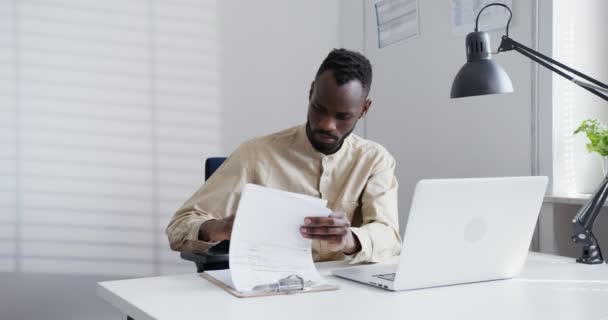 Nero uomo in camicia sfoglia un notebook prendere appunti in ufficio — Video Stock