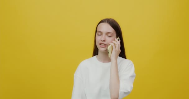 Jovem europeia experimenta sentimentos diferentes ao falar num telemóvel — Vídeo de Stock