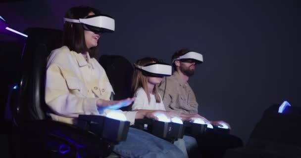Família europeia com um filho, em óculos de realidade virtual na atração 5D — Vídeo de Stock