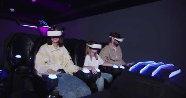 European family with one child, in virtual reality glasses on 5D attraction — Stock Video