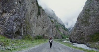Rusya, Kafkasya, Elbrus. Genç bir adam haritayı inceliyor, kayaların arasında yürüyor.