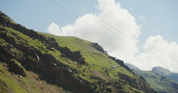 El helicóptero se eleva a la cima de una montaña rocosa — Vídeo de stock