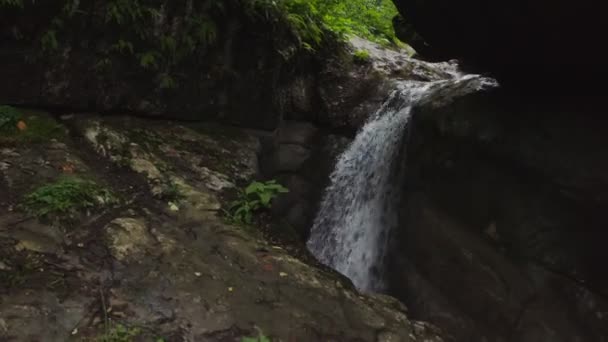 Un estrecho río de montaña que fluye como una cascada entre piedras, de cerca — Vídeo de stock
