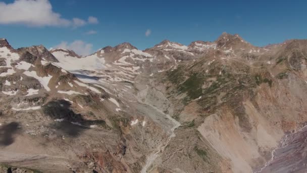 陡峭的岩石山，有悬崖和山崖，覆盖着雪和云彩 — 图库视频影像