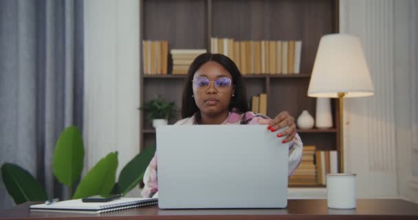 African american woman opens the lid of a laptop and starts a video call — Stock Video