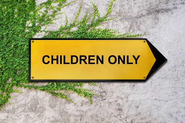 Children only on yellow sign hanging on ivy wall — Stock Photo, Image