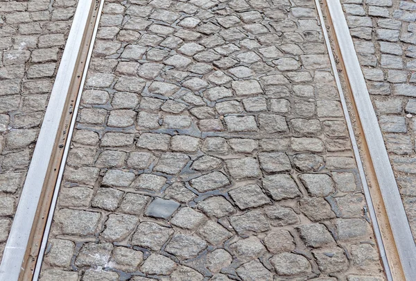 Old rail lines on cobbled road surface — Stock Photo, Image